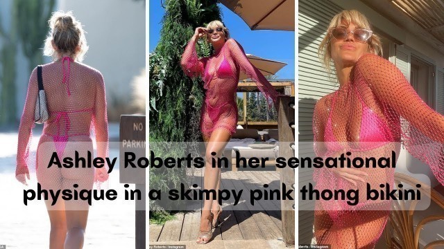 'Ashley Roberts flaunts her sensational physique in a skimpy pink thong bikini and mesh cover-up'