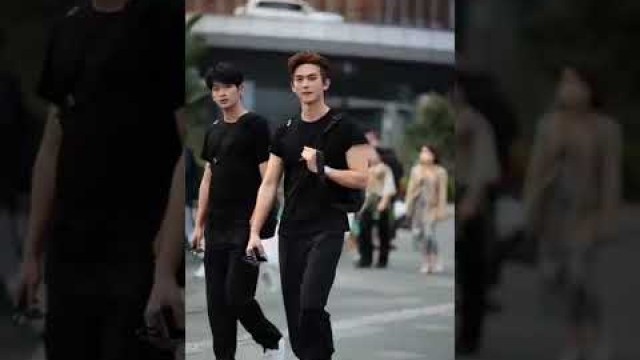 'Korean street fashion wear men.Cute Boys walking in the street.'